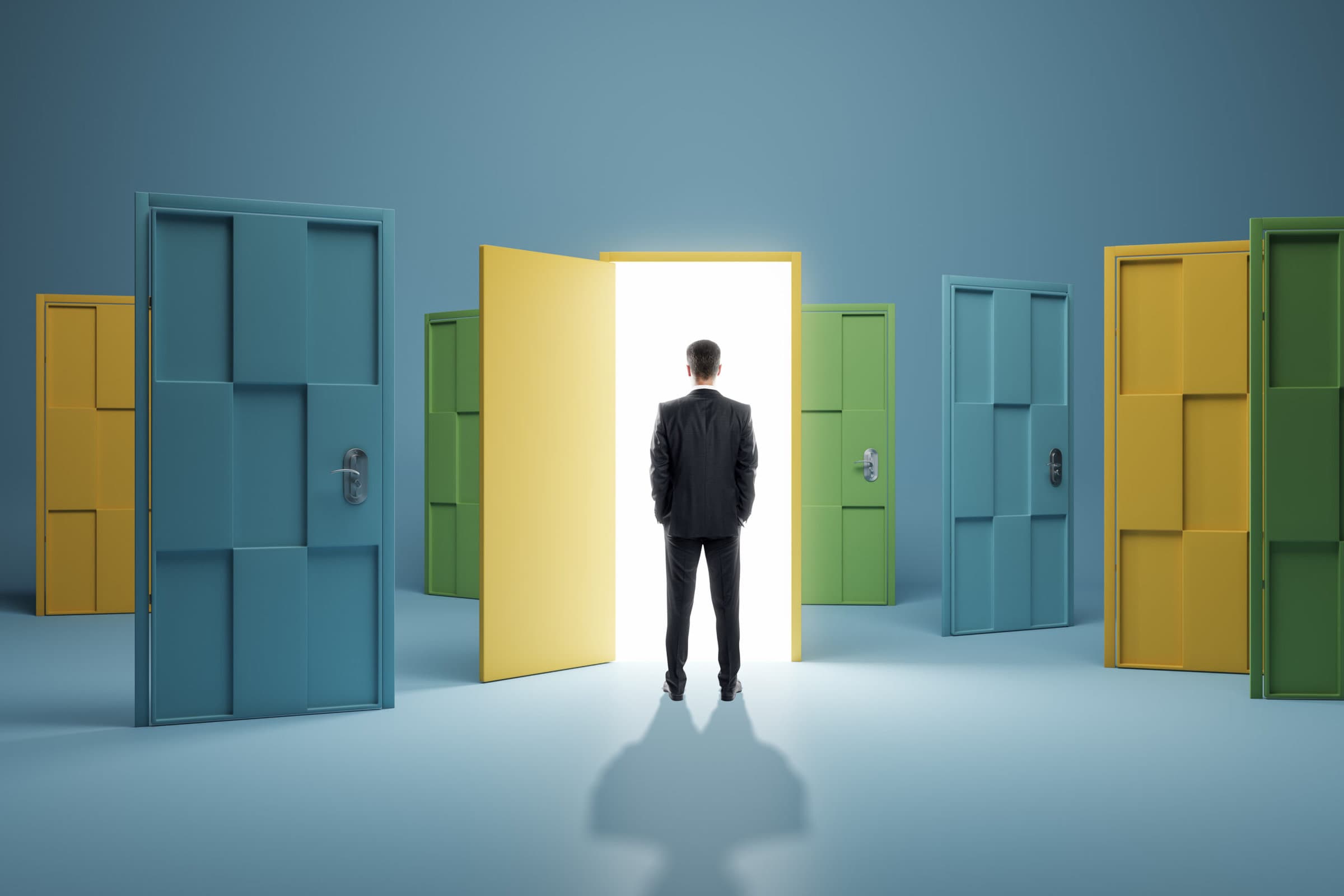 Man standing in front of abstract colorful puzzle door in interior. Future, choice, success, direction, opportunity and solution concept