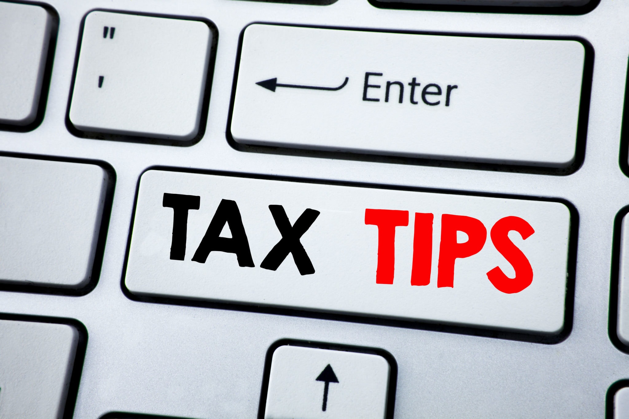 writing text showing tax tips. business concept for taxpayer assistance refund reimbursement written on white keyboard key with copy space. top view