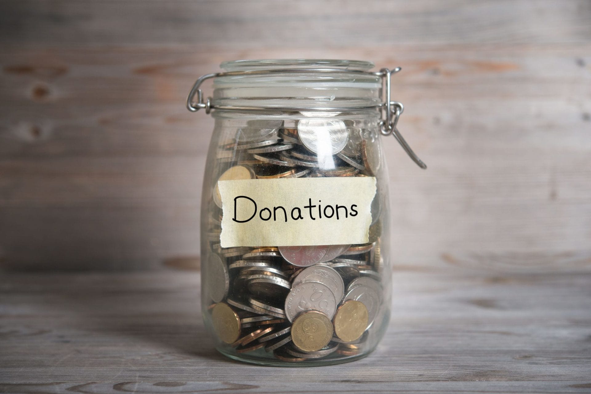 a jar of coins labeled "Donations"