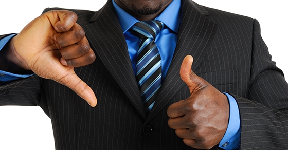 Business man showing thumbs up and down