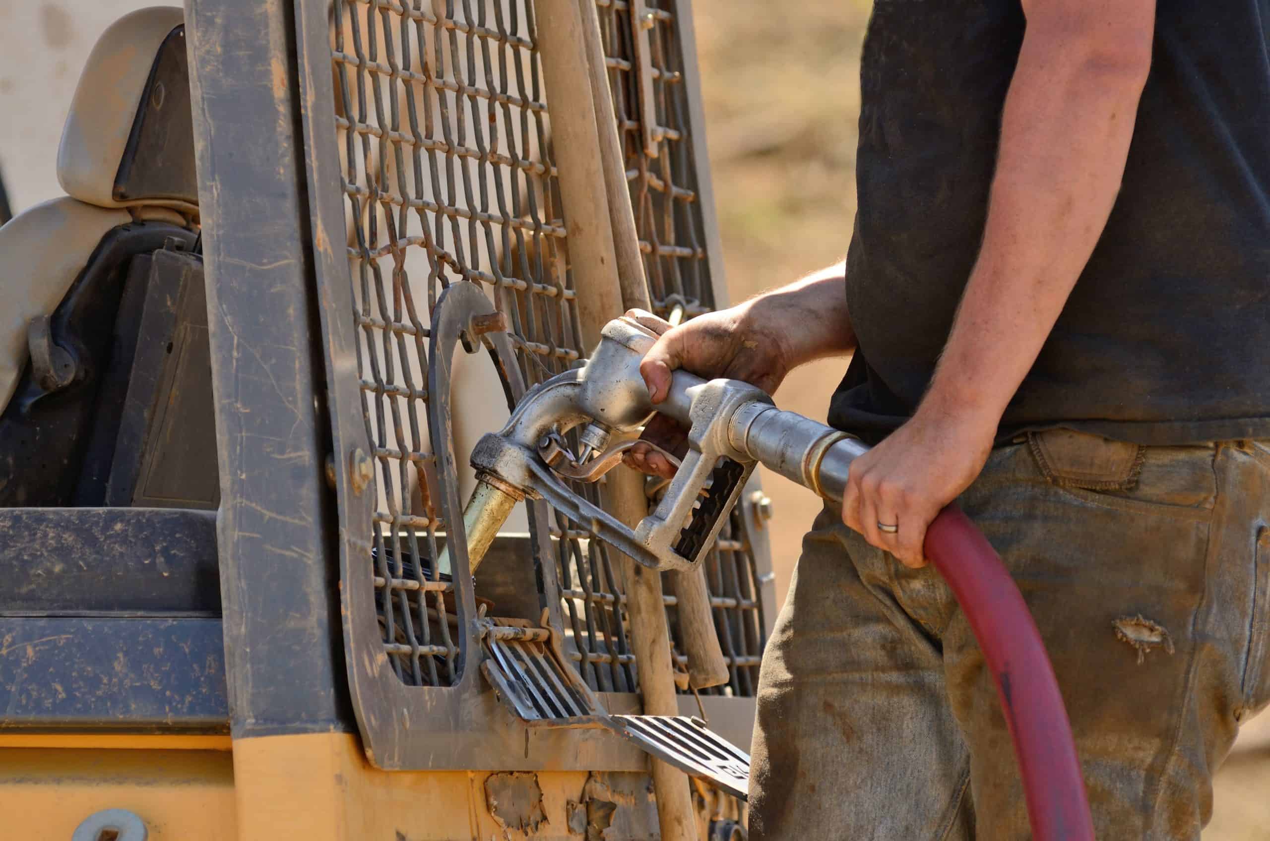 man holding a gasoline hose