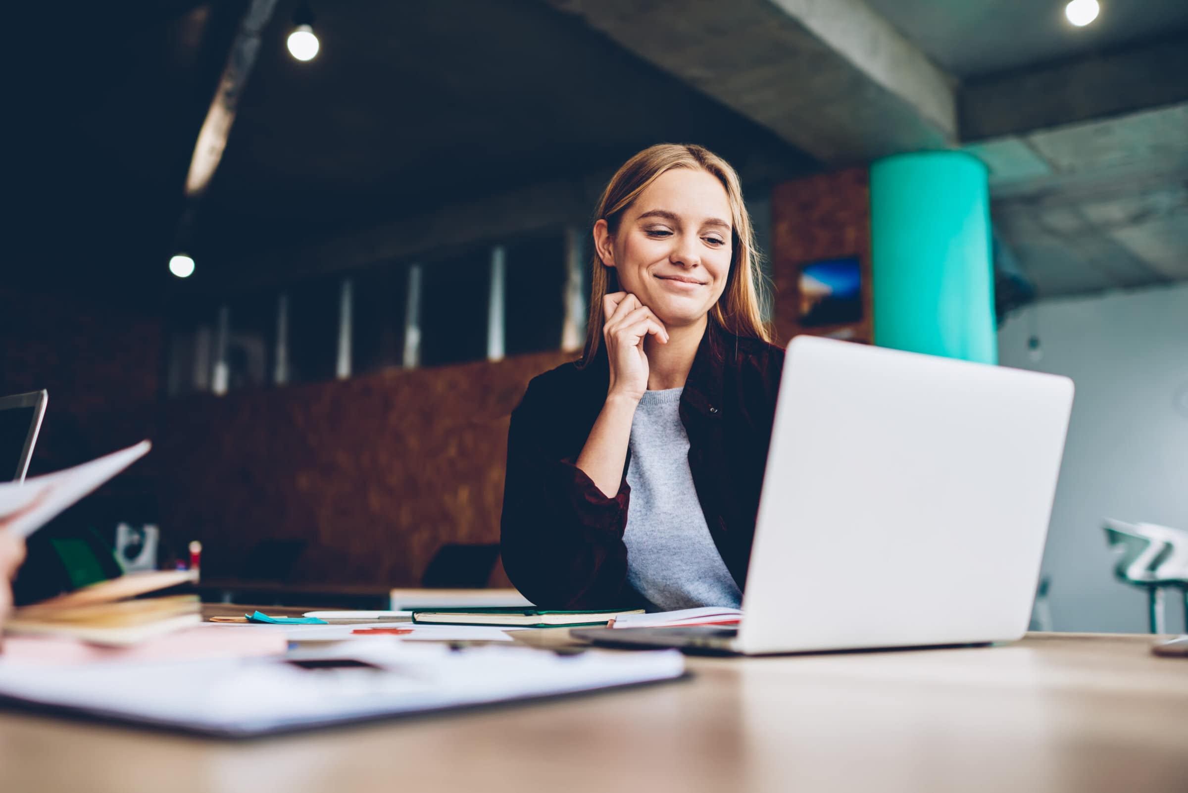 female employee smiling on her laptop