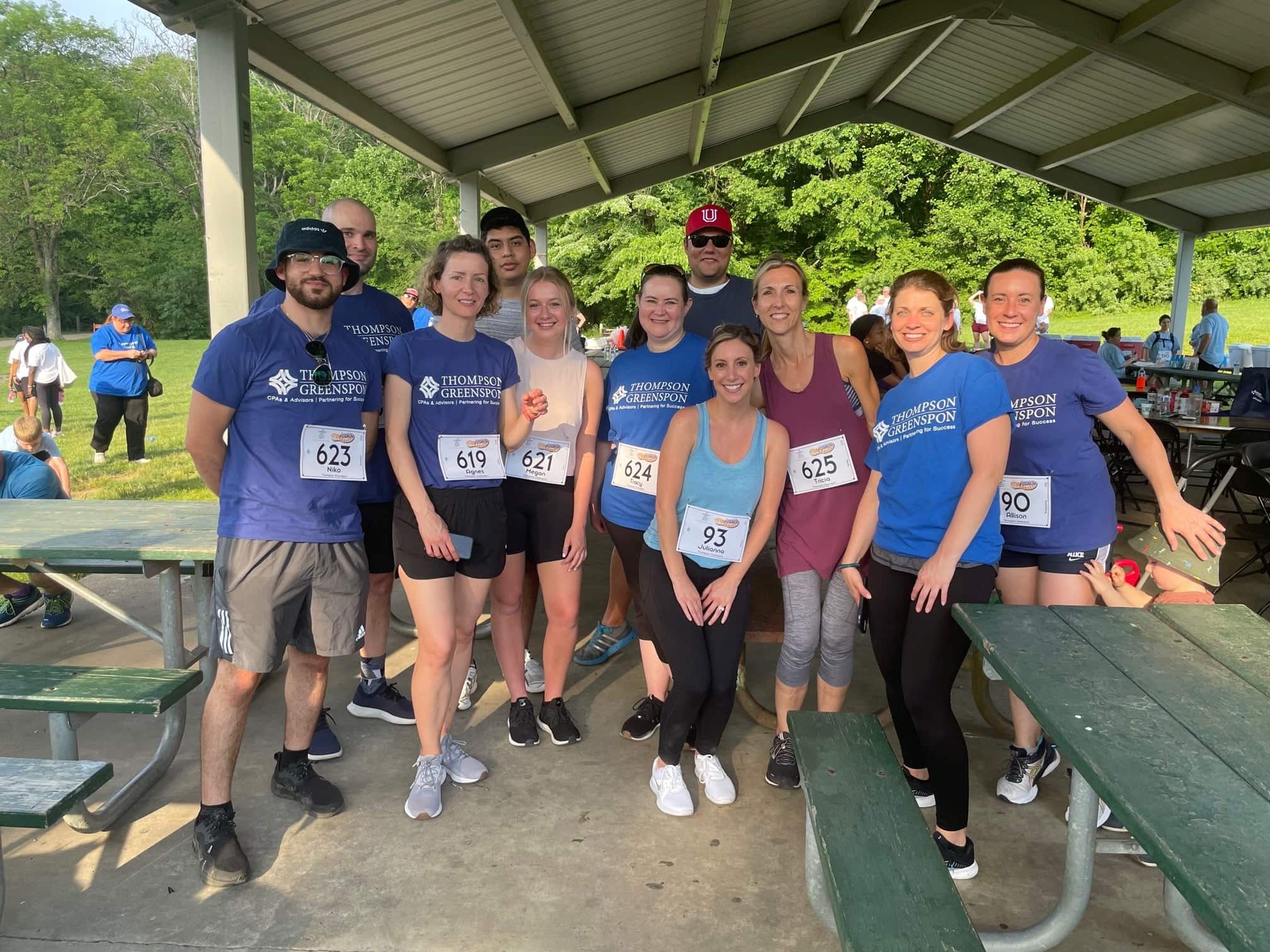 Coworkers doing a running race together in matching jerseys