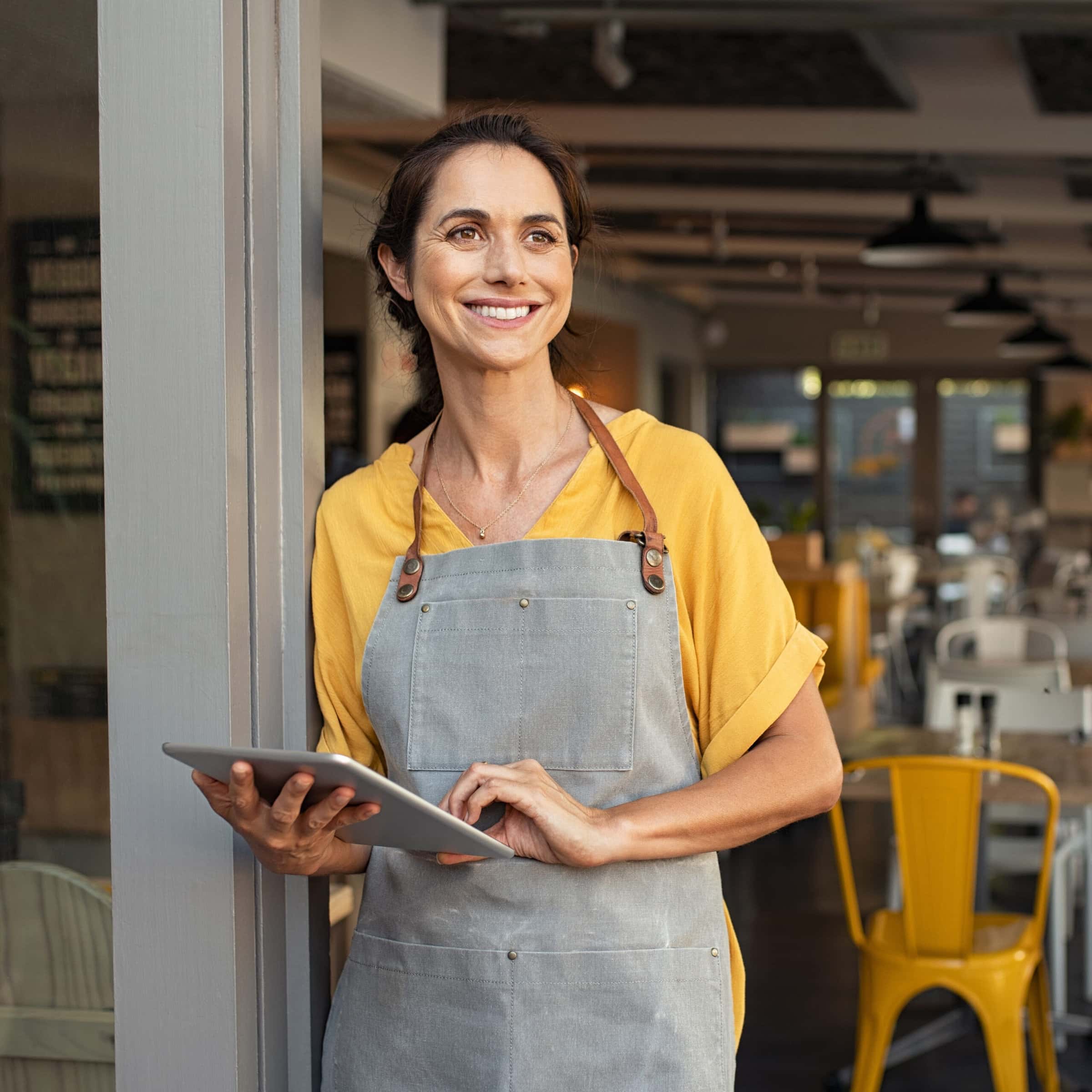 happy businesswoman holding a tablet