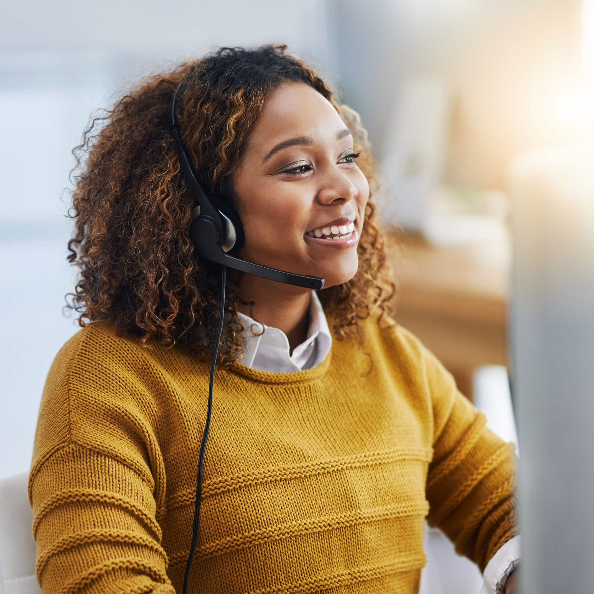 Dont forget to smile. Shot of a female agent working in a call centre. woman smiling during call