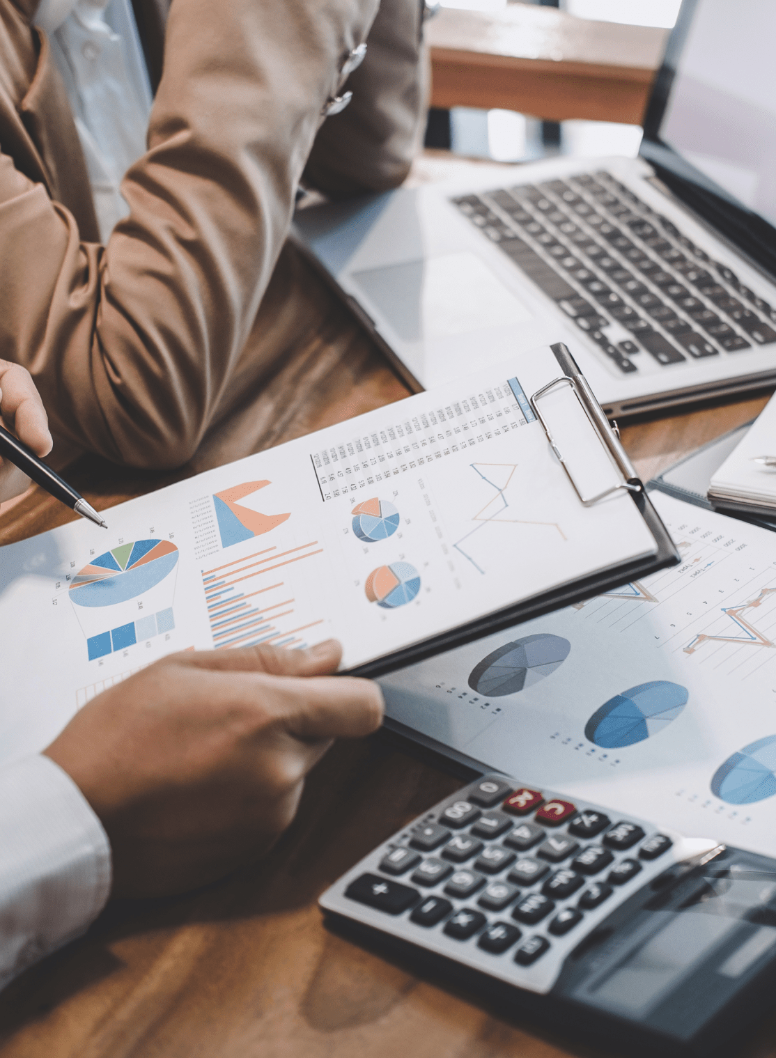 two people looking at a printout of statistics and graphs