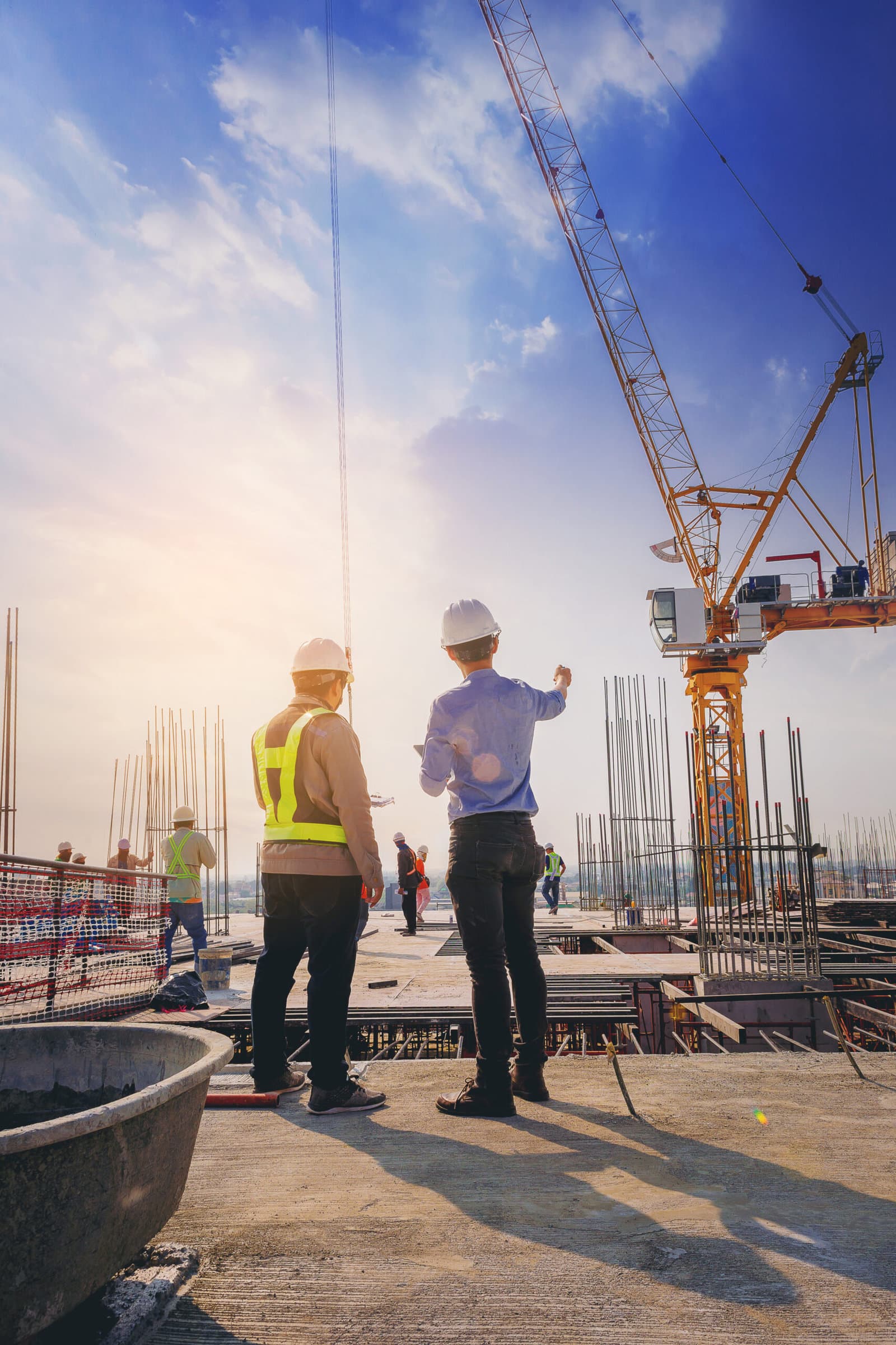 Two construction workers discussing plans at their work site