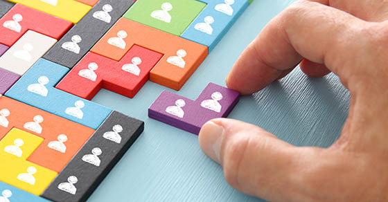 image of tangram puzzle blocks with people icons over wooden table ,human resources and management concept
