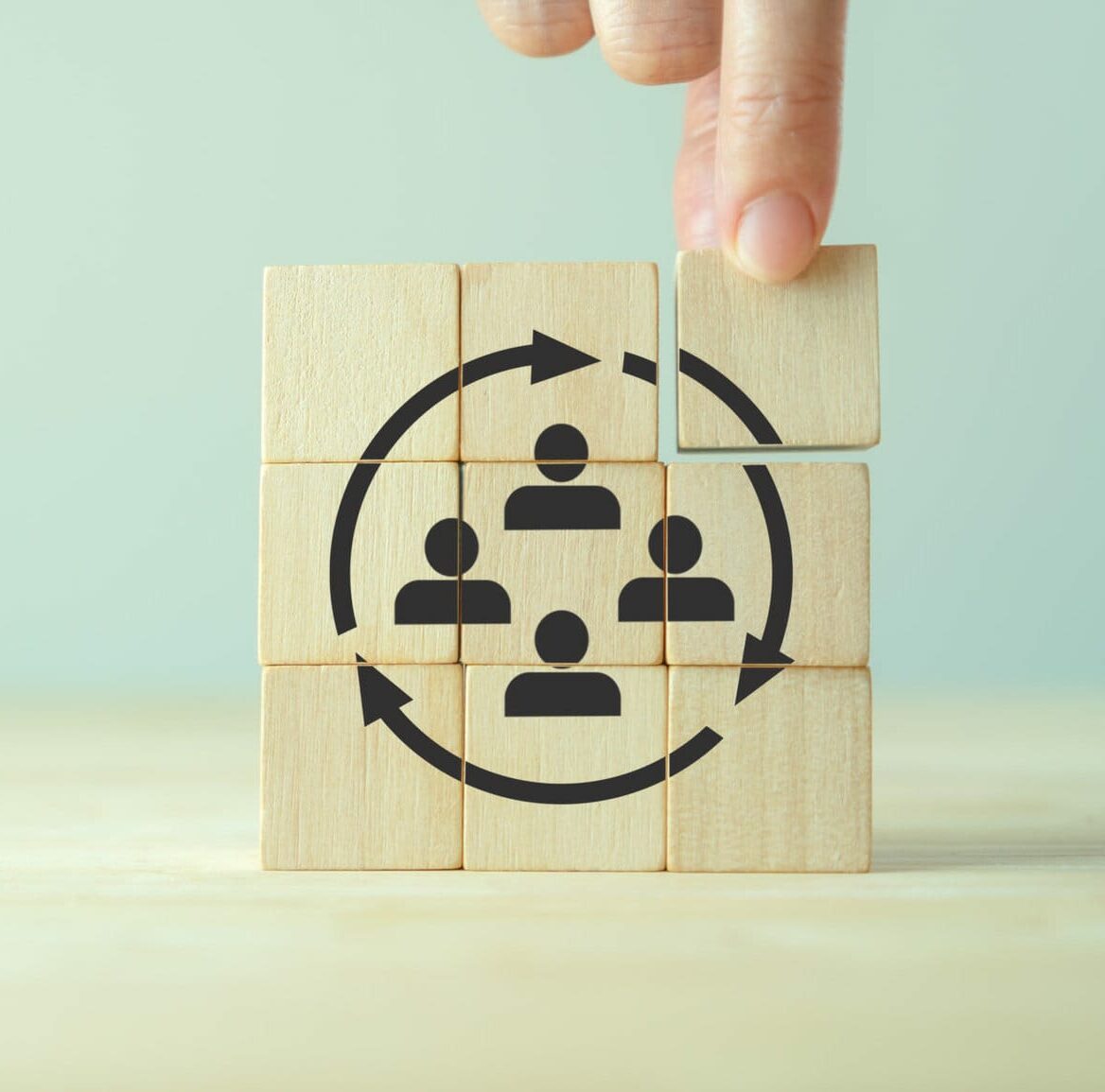 Manpower planning and management concept. Forecasting future staffing needs, analyzing current staffing levels and developing human resource strategies. Wooden blocks with manpower or staffs icons.