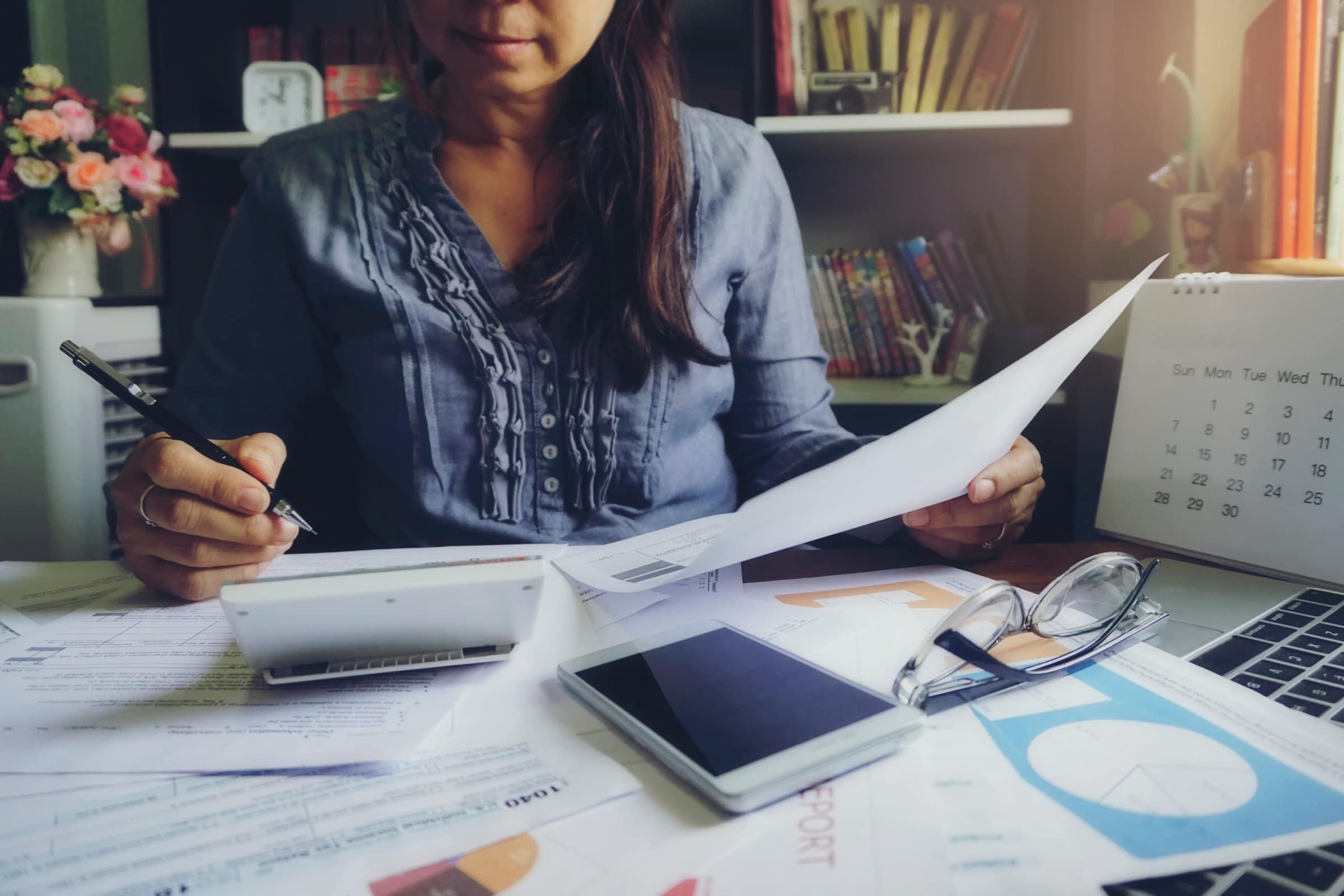 Budget planning concept,Accountant is calculating company's annual tax.Calendar 2020 and personal income tax forms for those who have income under US law placed on office desk.