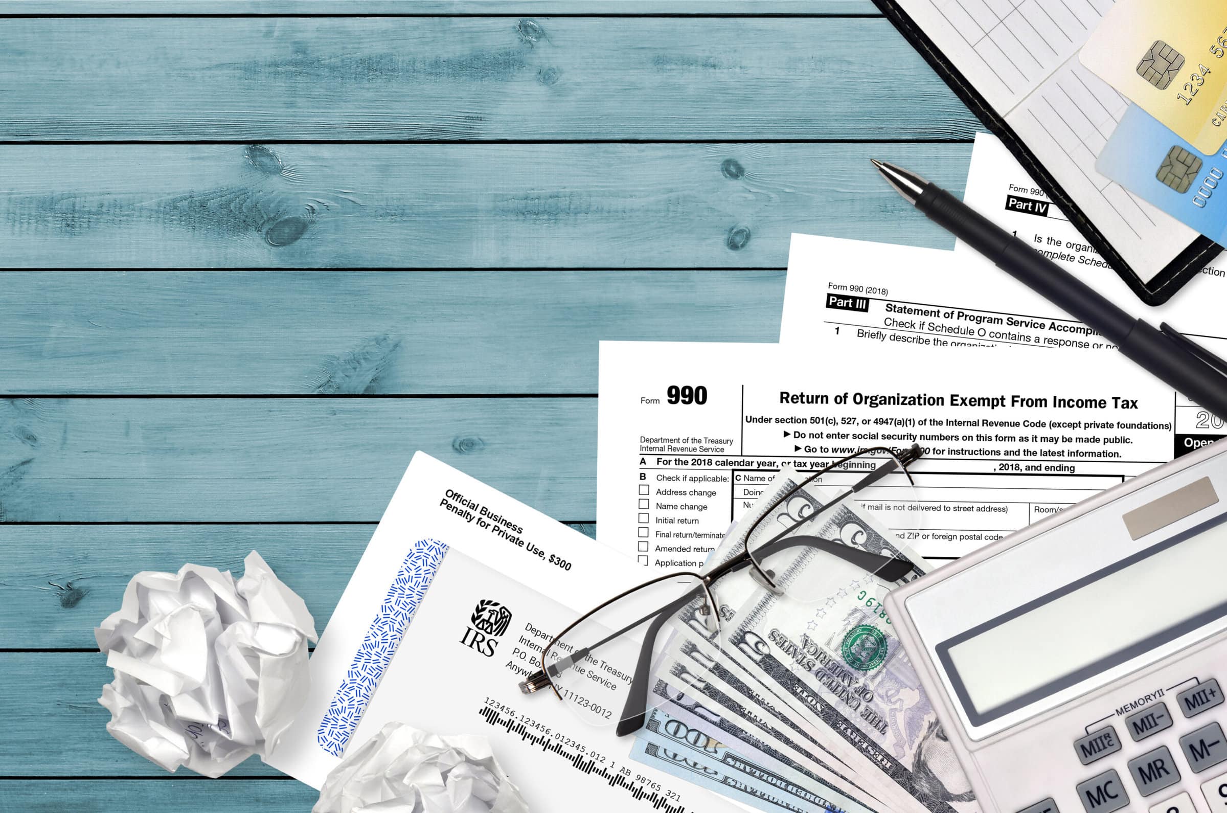 IRS form 990 Return of organization exempt from income tax lies on flat lay office table and ready to fill. U.S. Internal revenue services paperwork concept. Time to pay taxes in United States