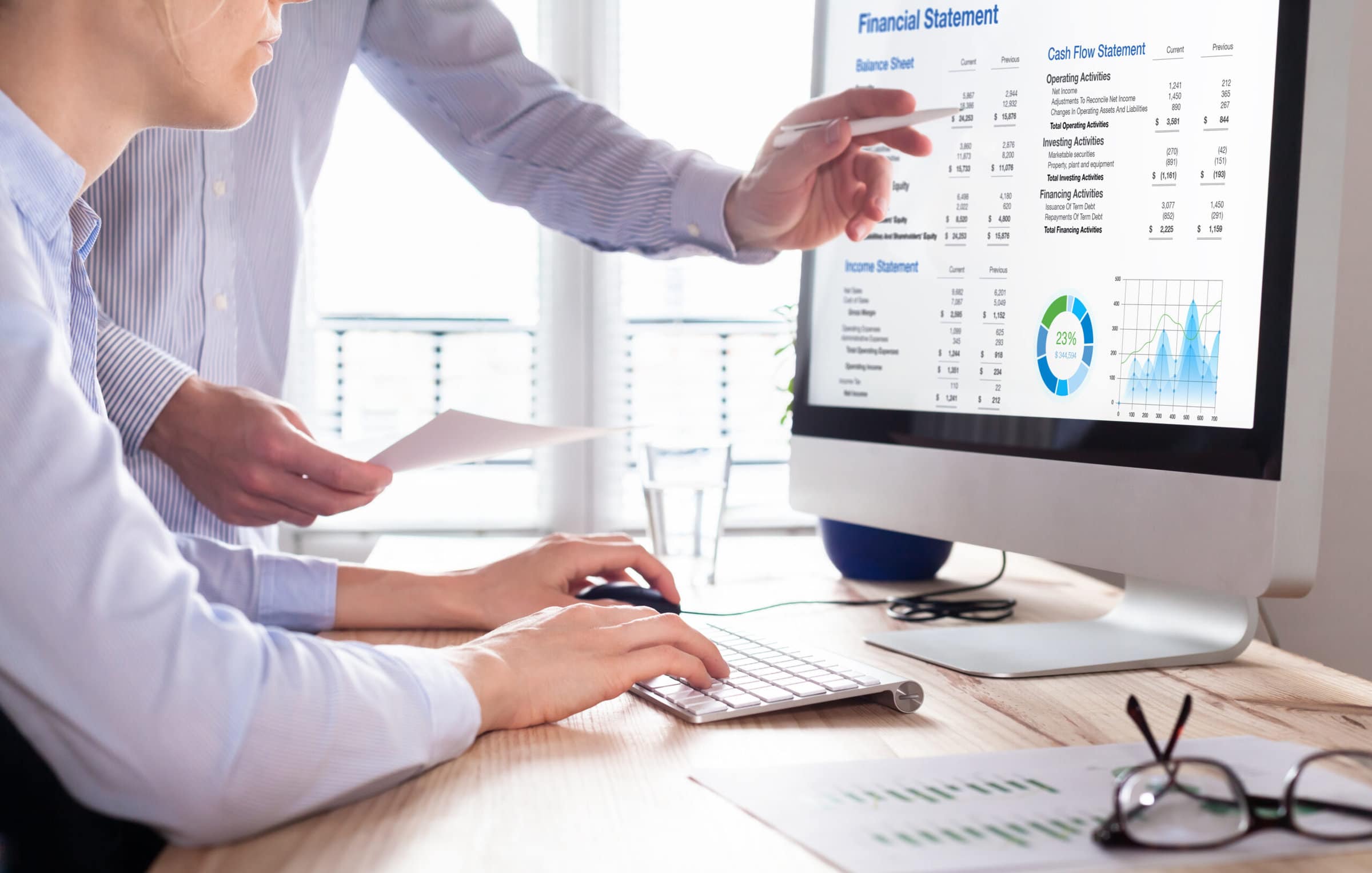 Accountants working on financial statement on computer screen in office. Team of consulant auditing finance and business operations reports with income data. Corporate management and governance