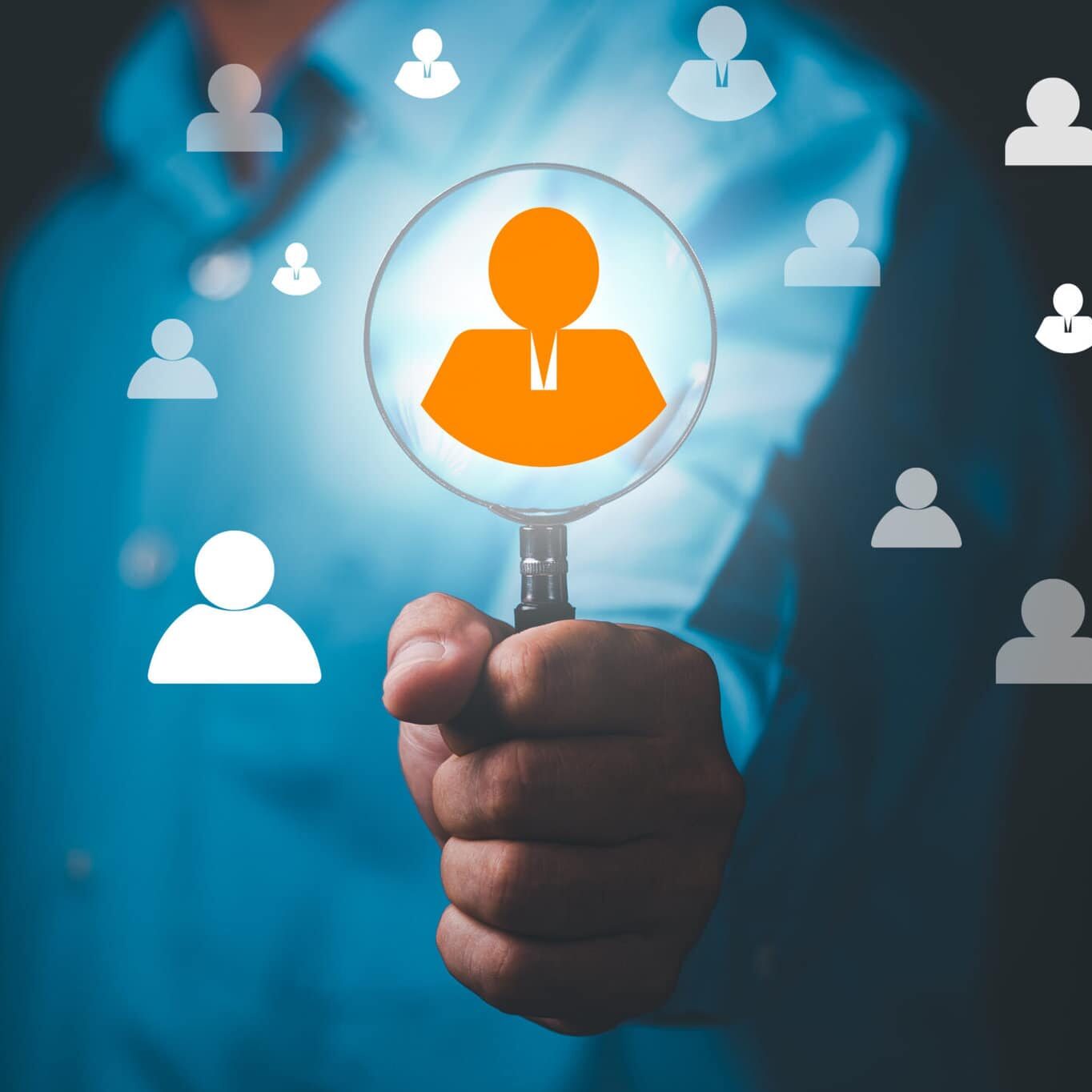 young businessman holding a magnifying glass , icon showing selection ,Leadership and Excellence,Effective personnel management in the organization