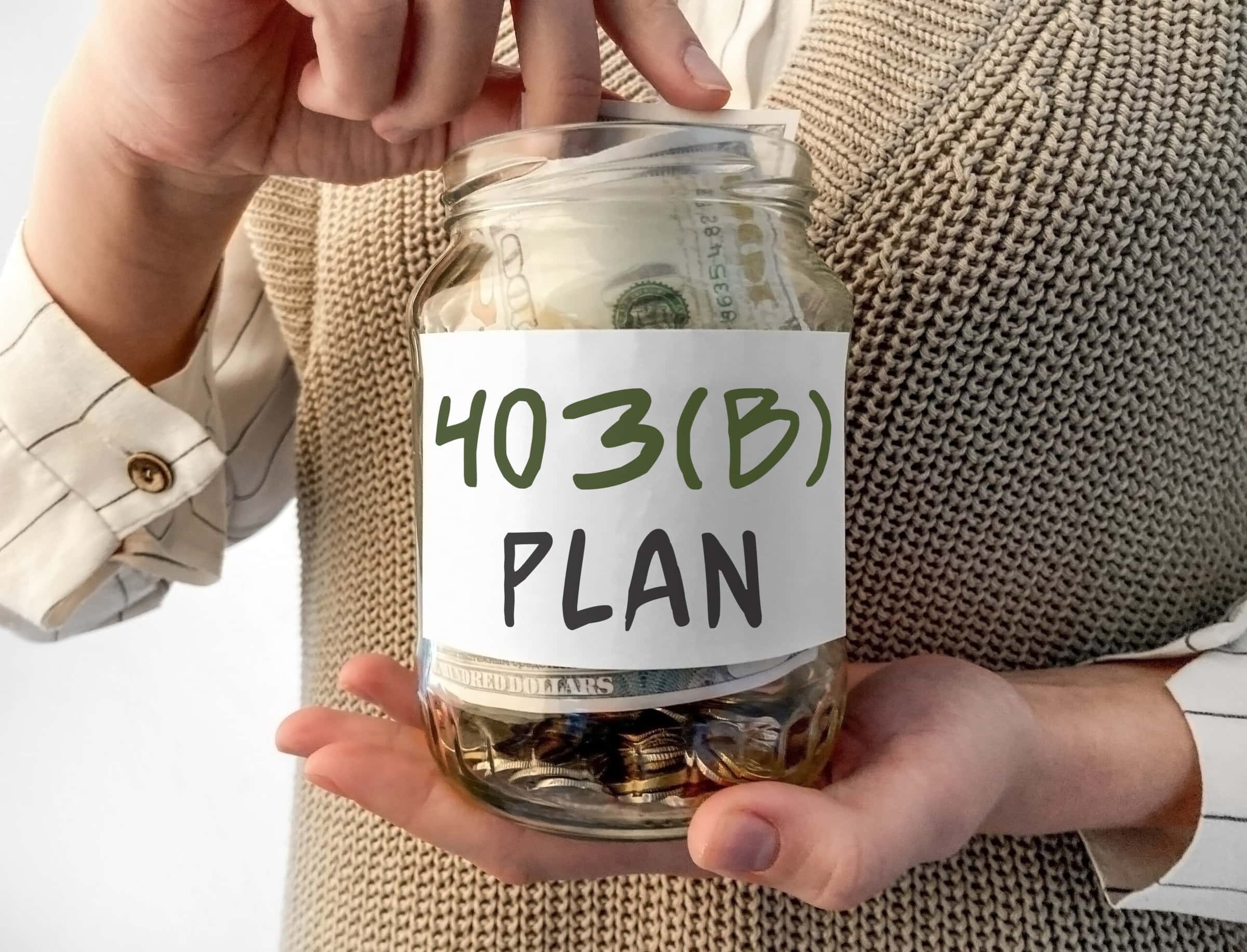 Woman holding glass jar with money inside with word 403 b plan