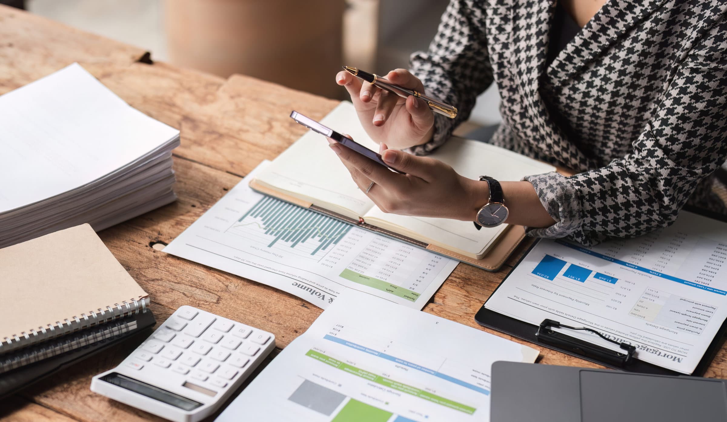 Close up, Business woman using calculator for do math finance on wooden desk in office and business working background, tax, accounting, statistics and analytic research concept..