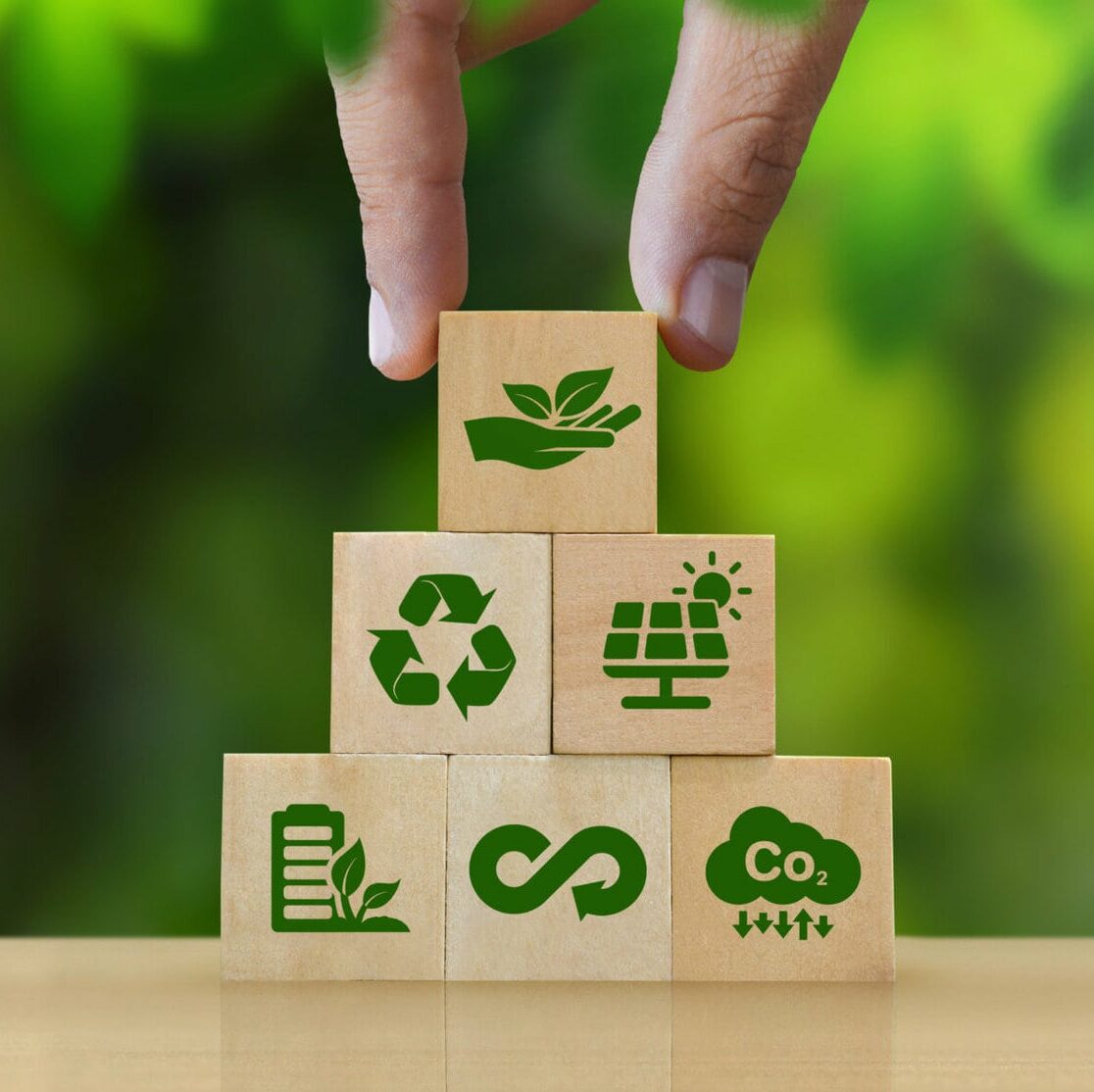 ESG Concepts in Environment, Society and Governance Sustainable Organization Development Hand holding a wooden block with green ESG icon on green nature background. copy space