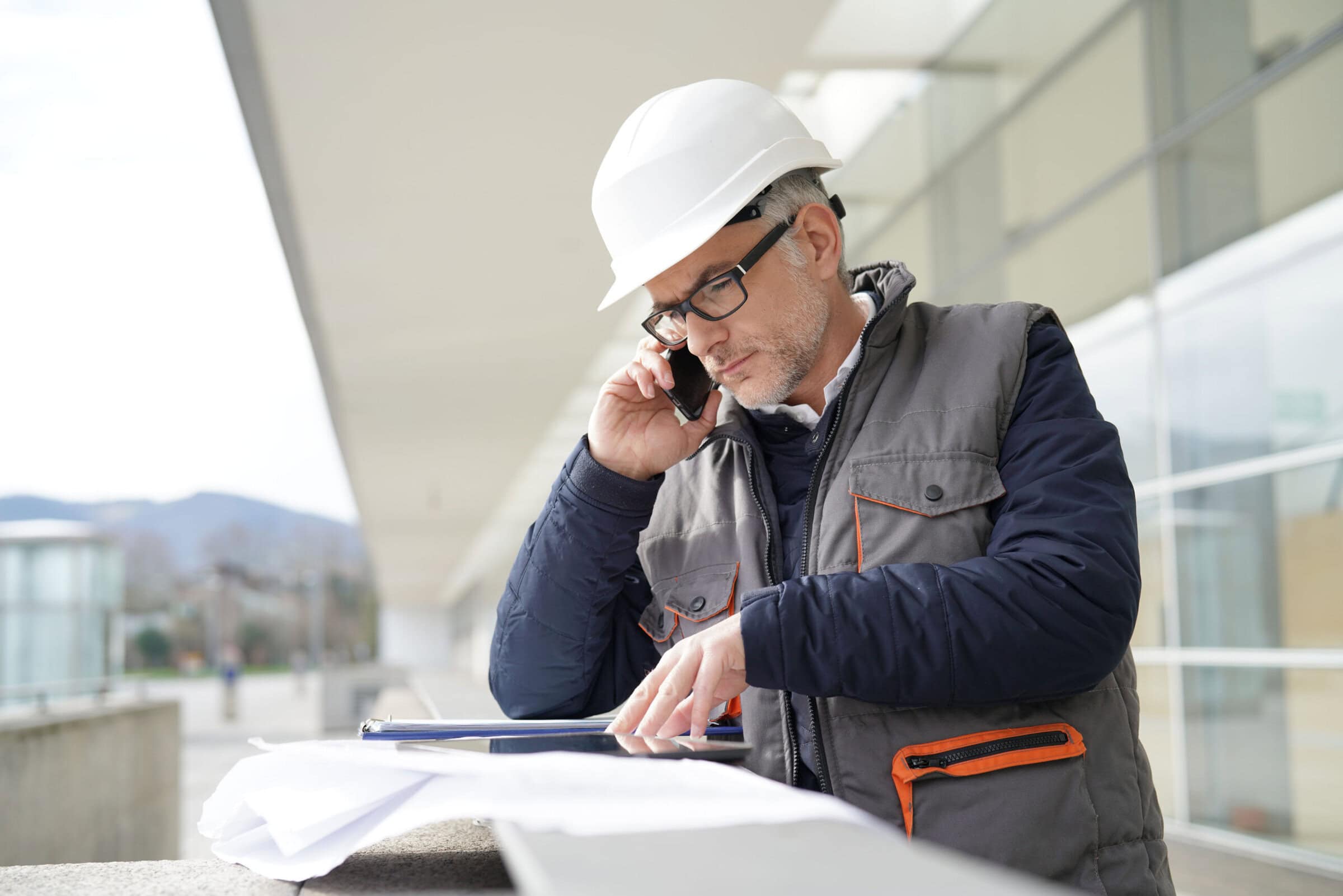 Engineer working on outdoor project and talking on phone