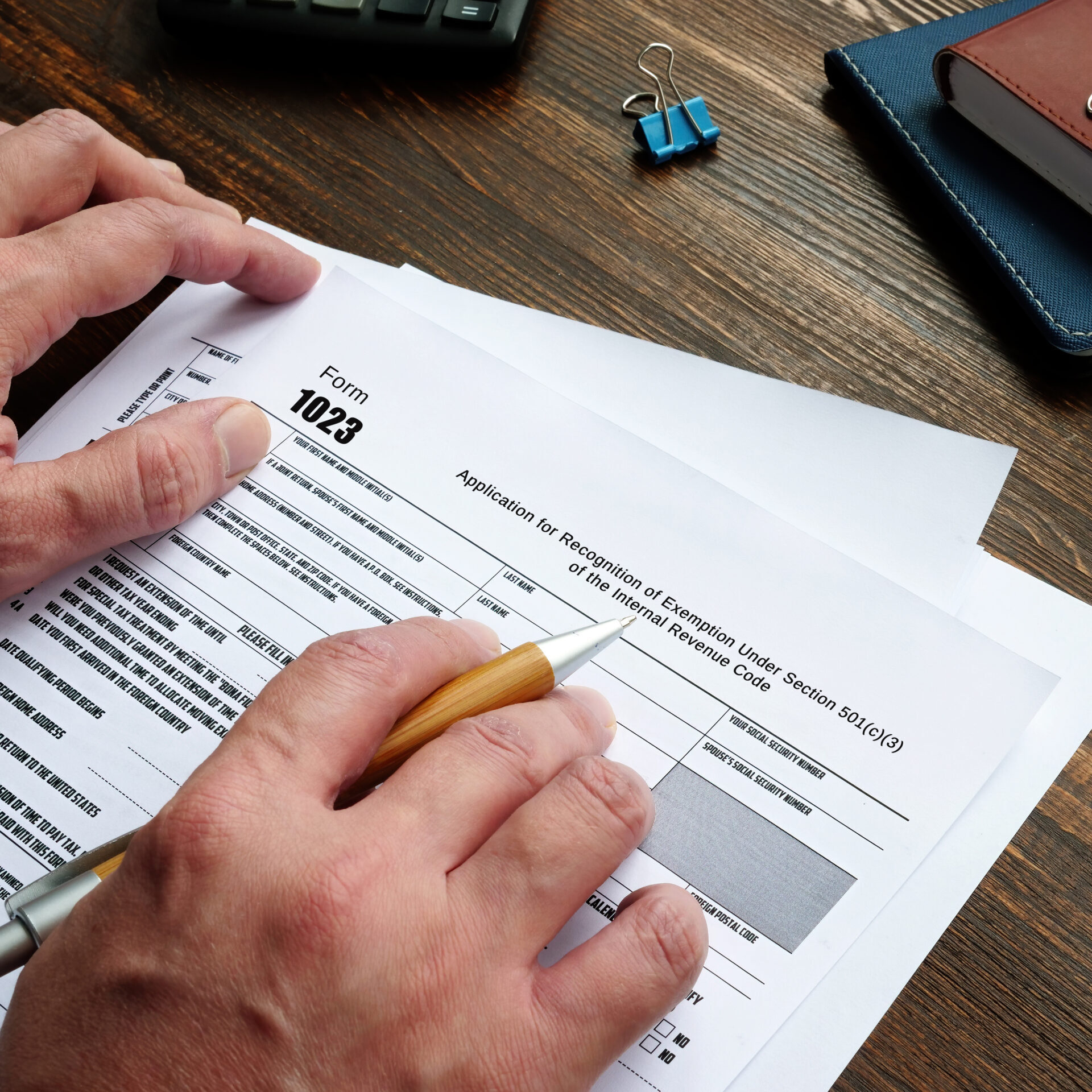 Business concept meaning Form 1023 Application for Recognition of Exemption Under Section 501(c)(3) of the Internal Revenue Code with inscription on the sheet.
