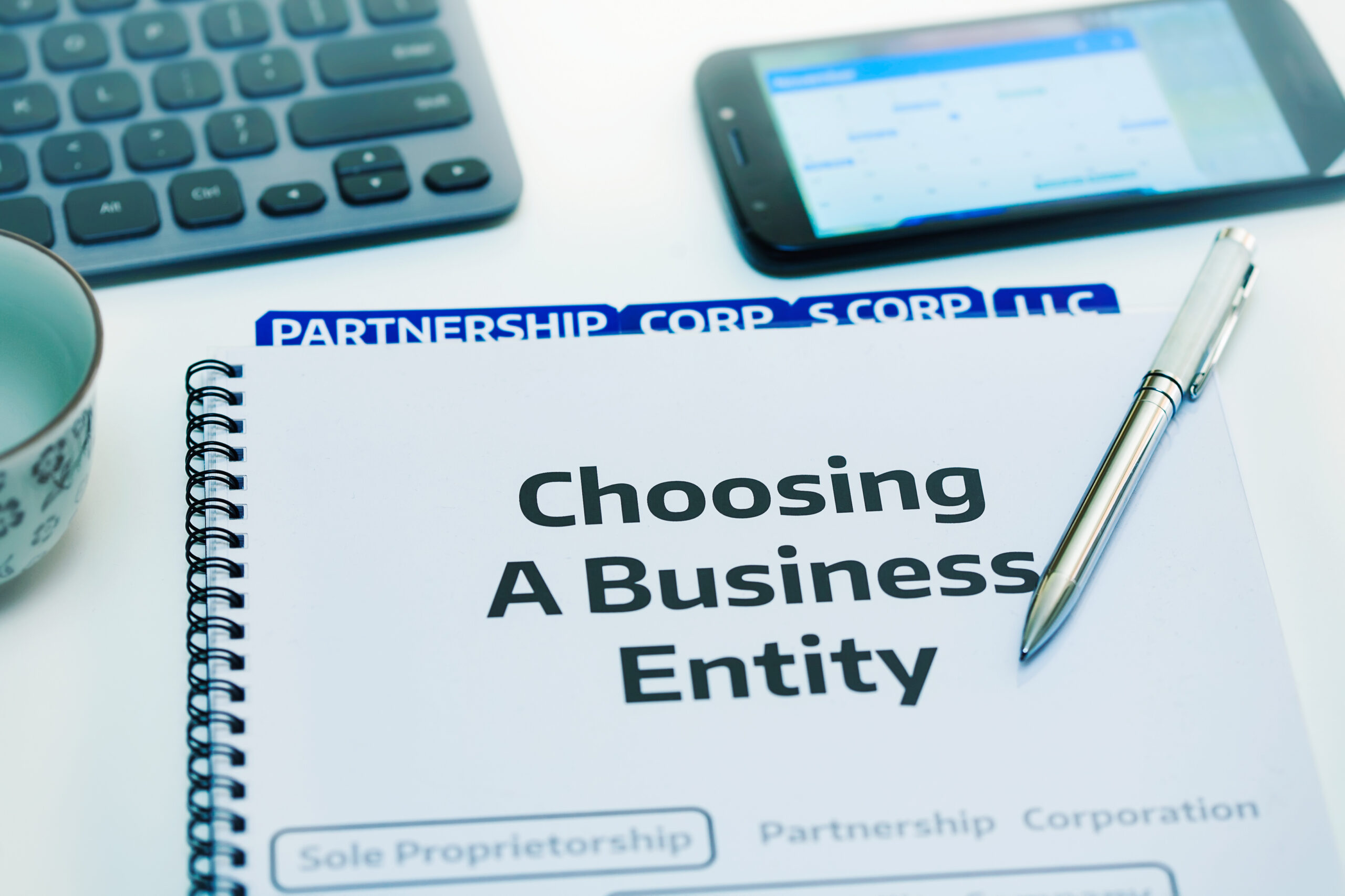 Startup company desk reviewing the different types of business entities.