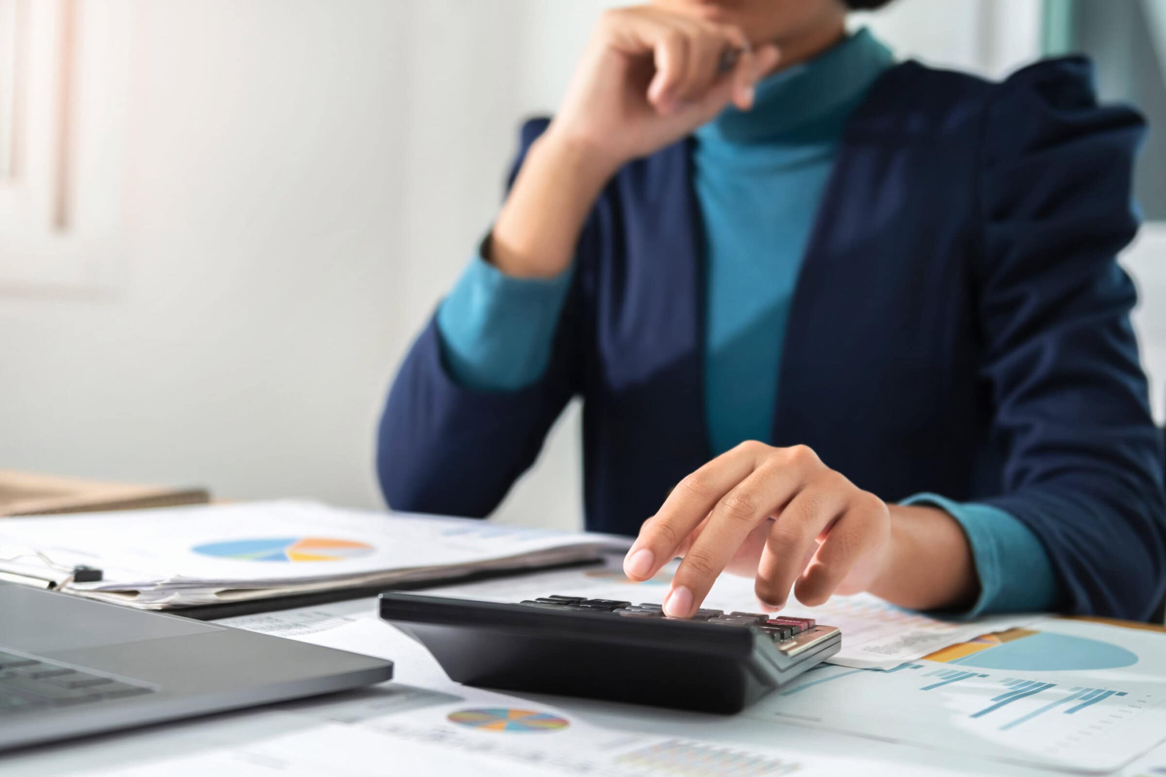 businesswoman  working using calculator and laptop in office. concept finance and accounting