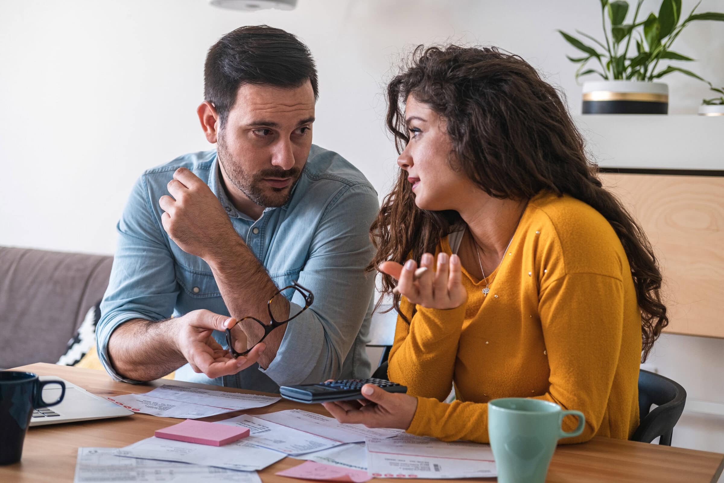 Young couple calculating finance at desk stock photo