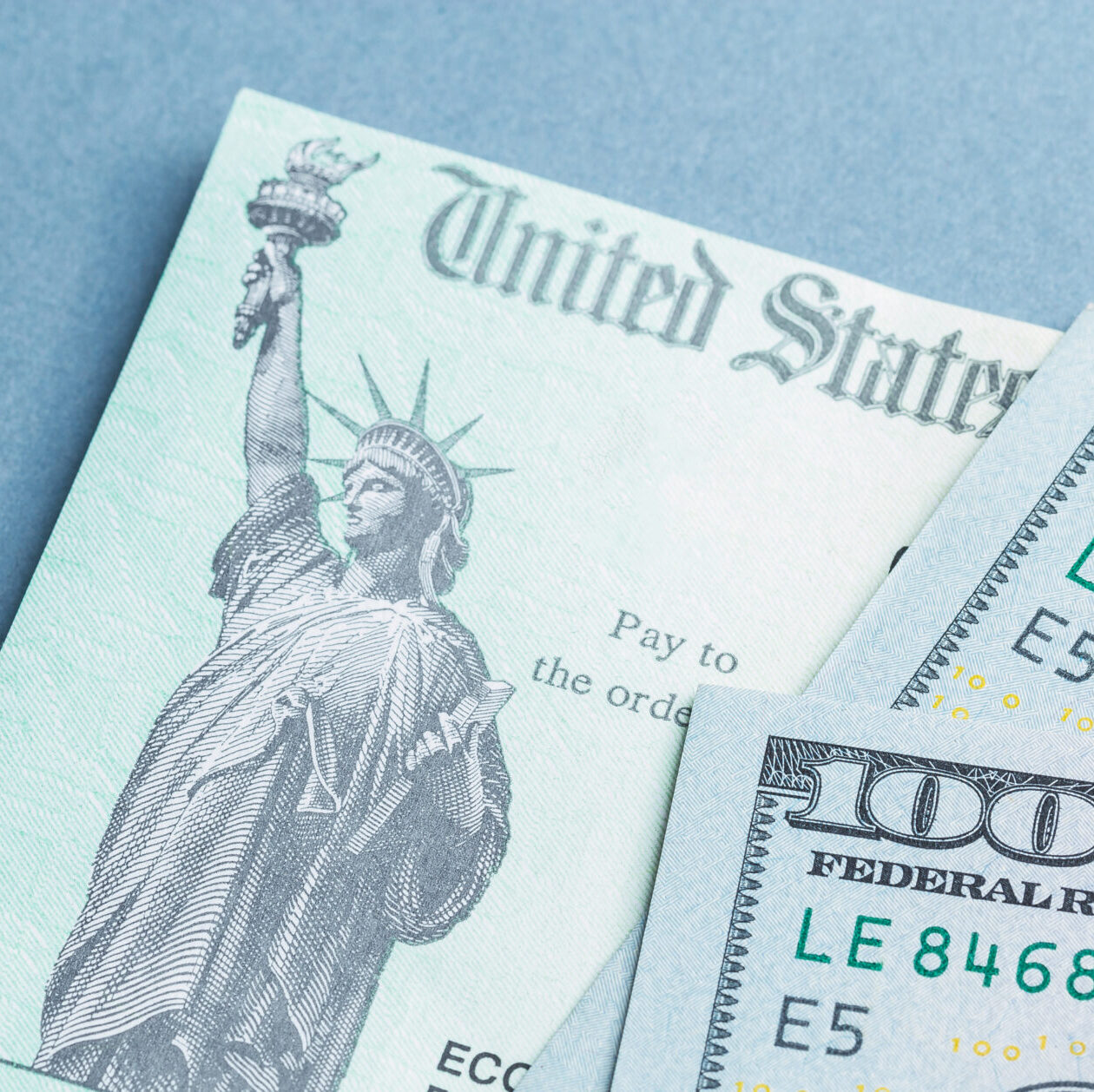 A tax return stimulus check with some American hundred dollar bills