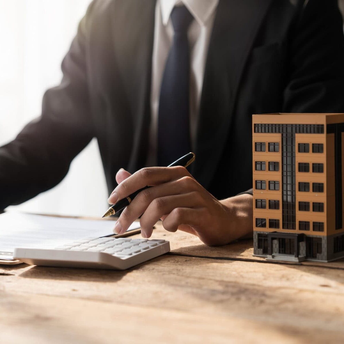 Entrepreneurs, business owners, accountants, real estate agents, A young man using a calculator to calculate his home budget to assess the risks of investing in real estate...